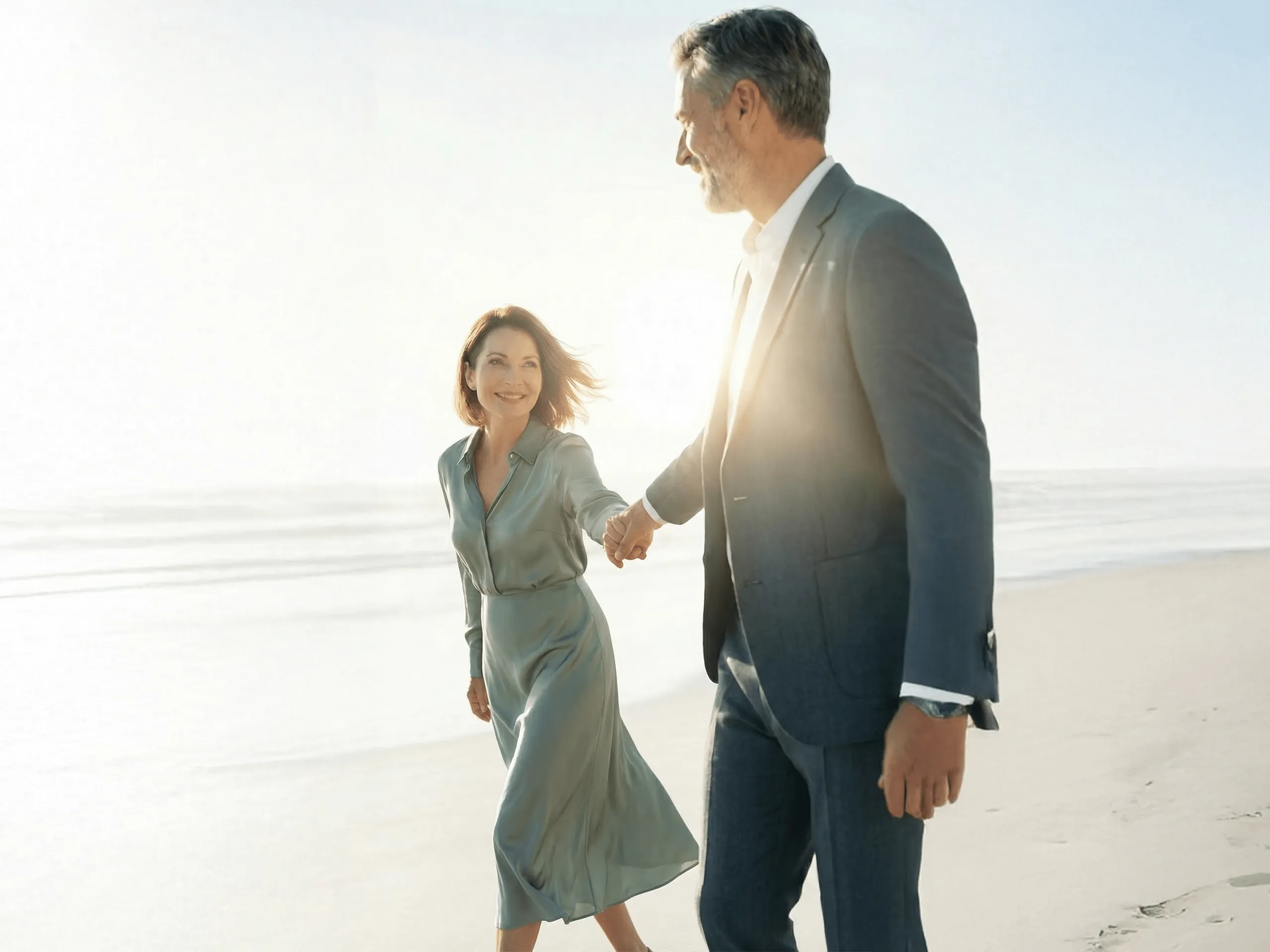 Couple walking on the beach — aspirational longevity lifestyle